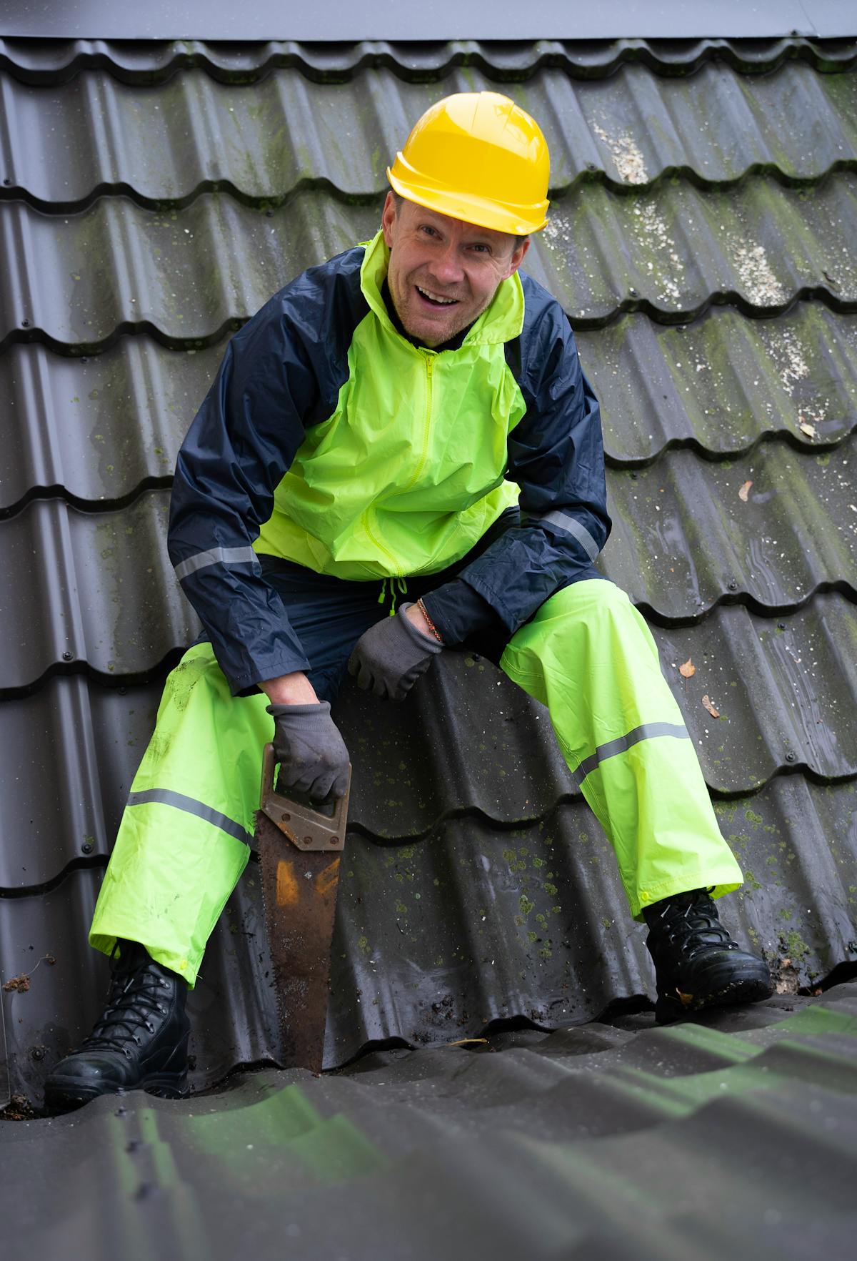 Construction worker performing roof maintenance work