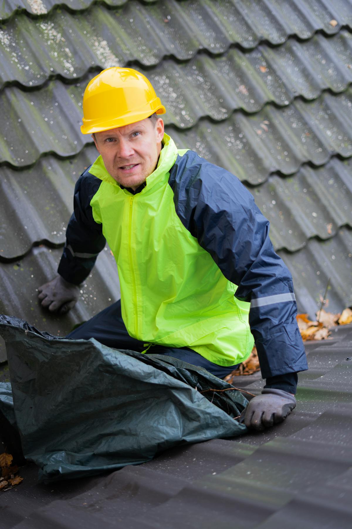 Inspector in safety vest and helmet examining a building